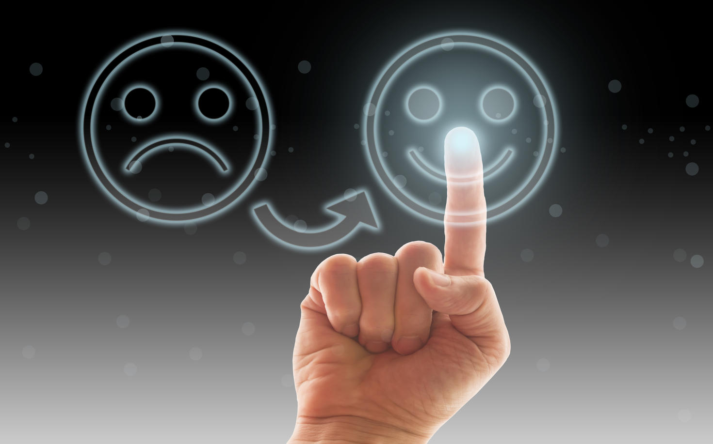 Sad smiley face with arrow pointing to happy smiley face with index finger pointing to the happy face
