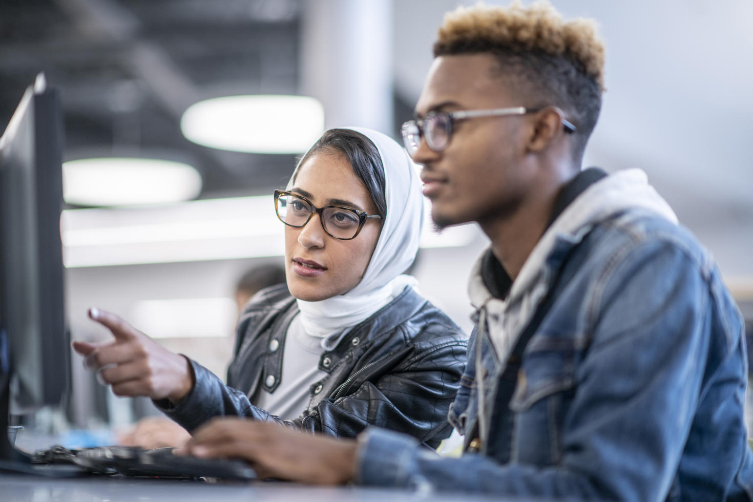 two students in front of a computer