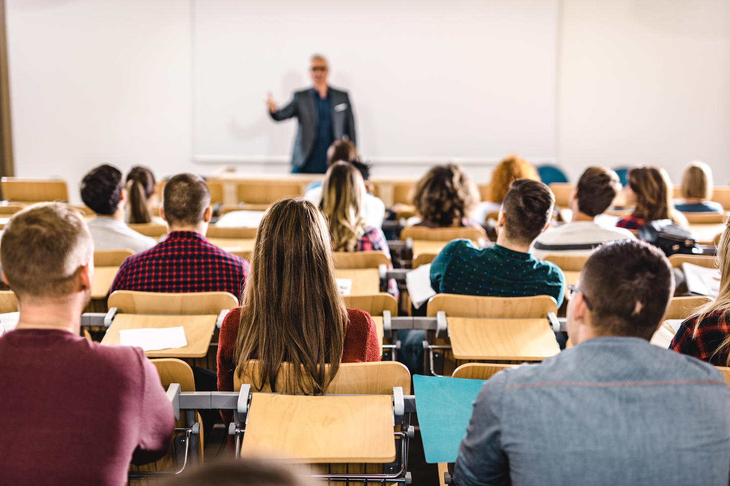 Rear view of a large group of students in a lecture hall
