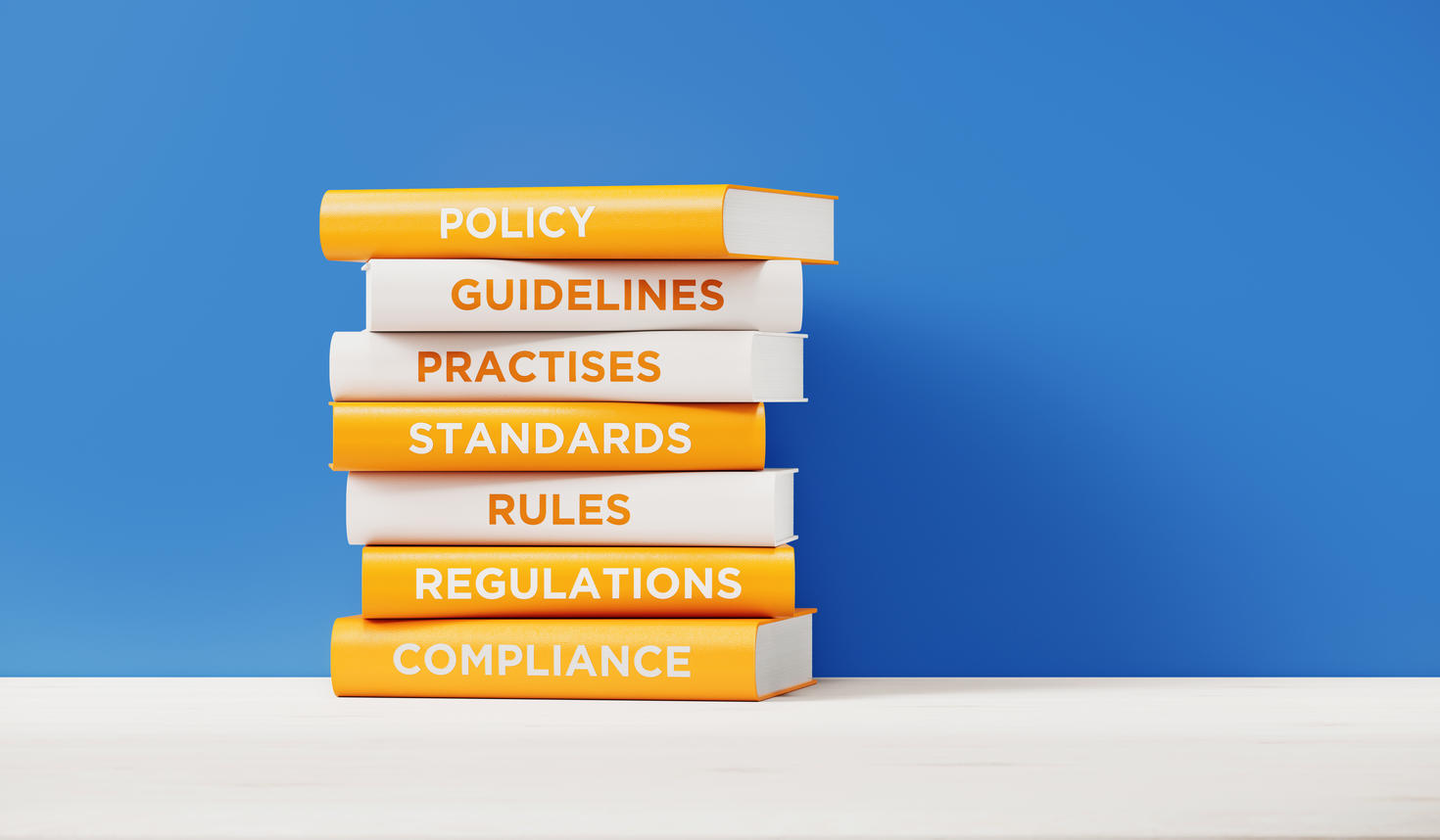 A stack of books on a table with a blue background