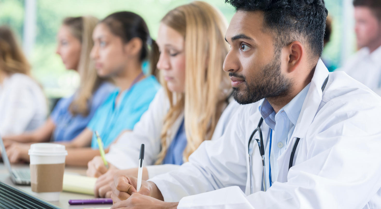 medical student takes notes during class