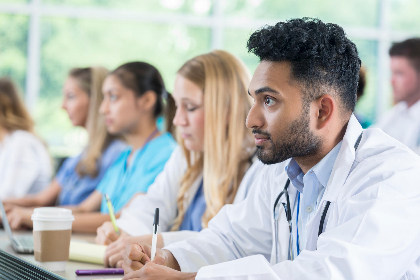 Medical students taking notes during class