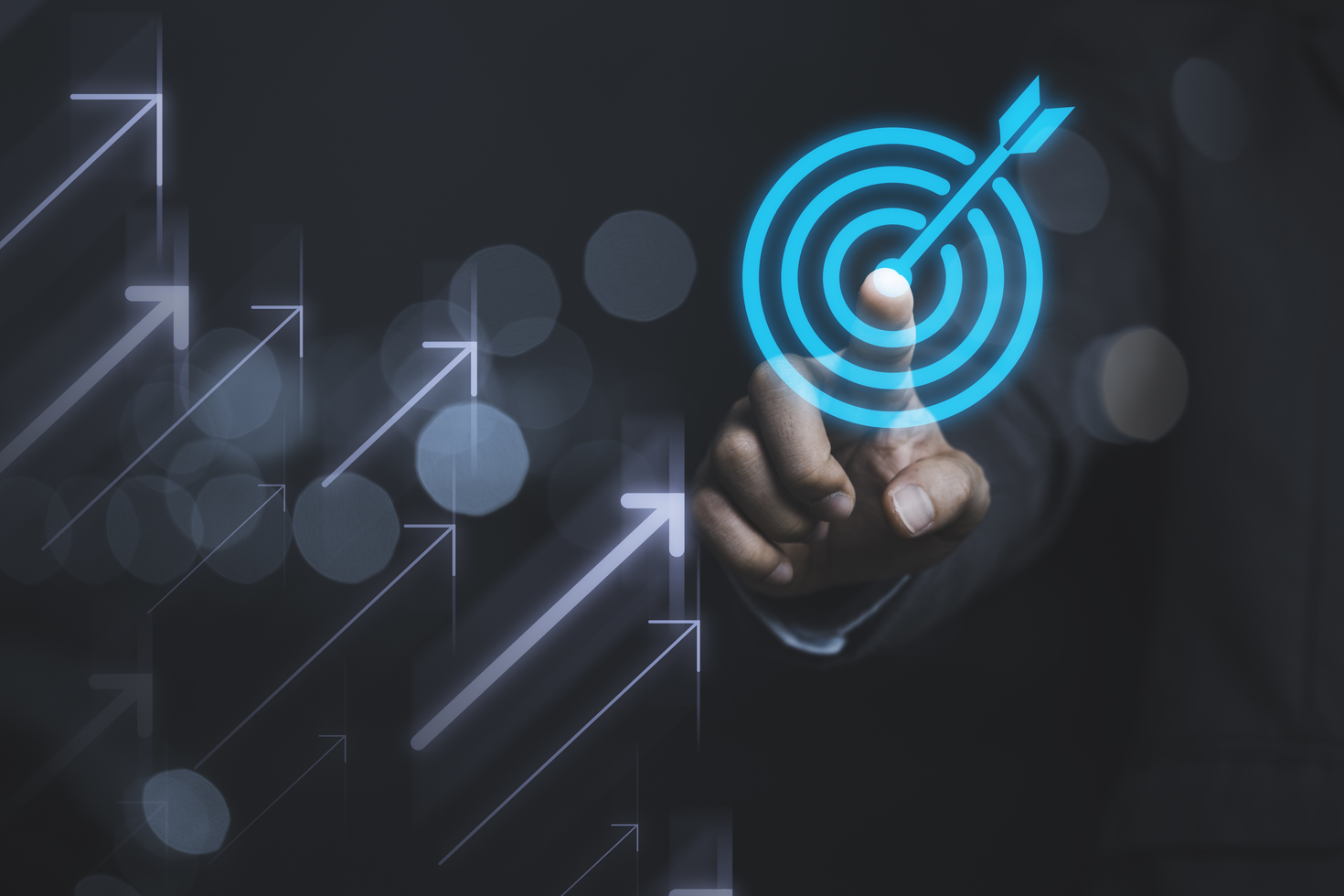 Businessman touching virtual dartboard with arrow