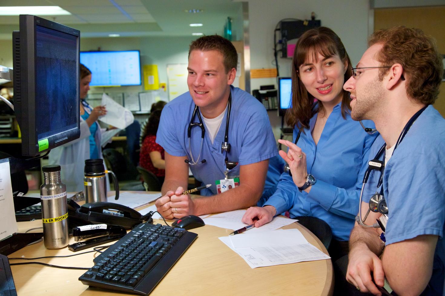 Two Emergency Physicians and Undergrad student discussing patient's xray