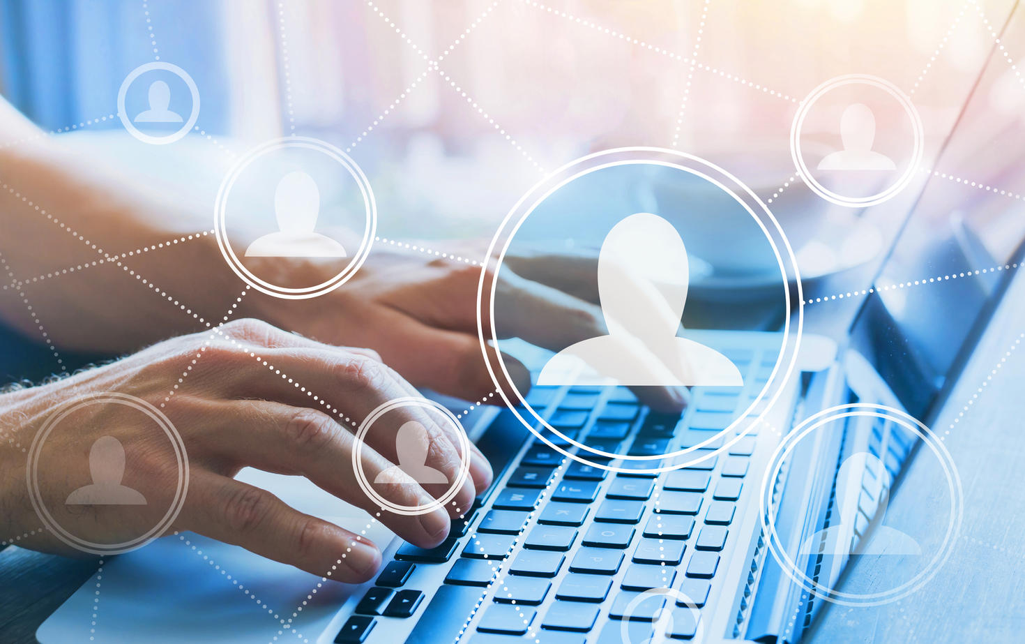 Hands typing on computer keyboard with company people icons