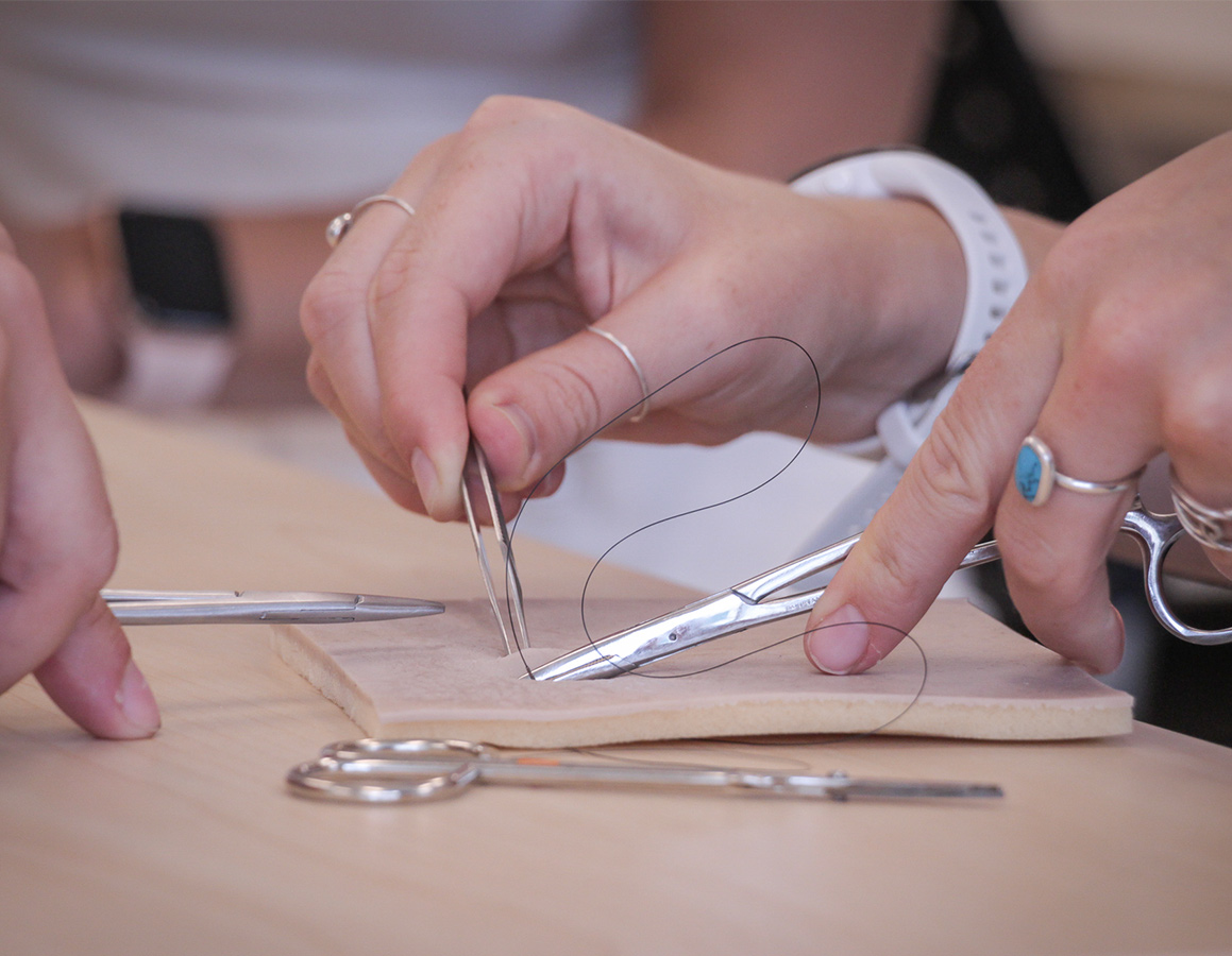 Students practicing stitching points