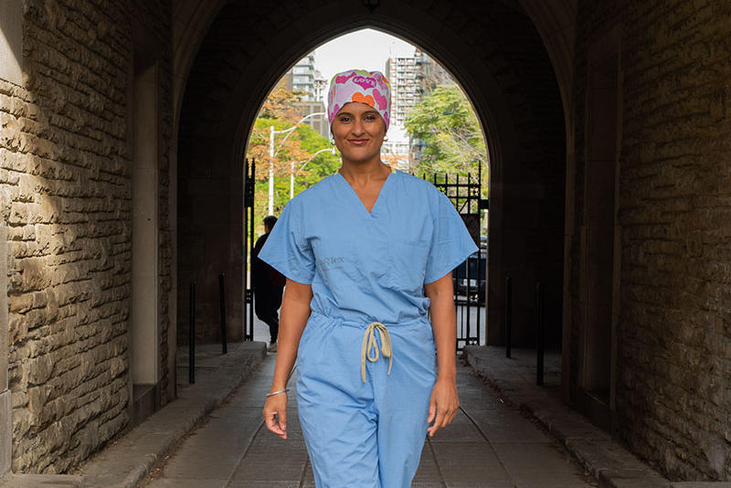 A woman stands in a corridor.