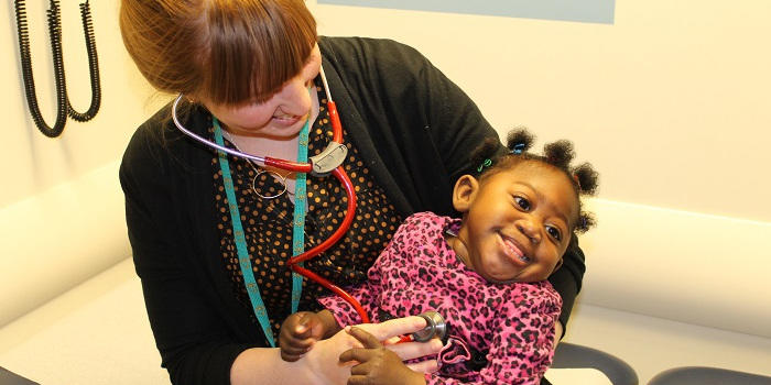A doctor carrying a baby