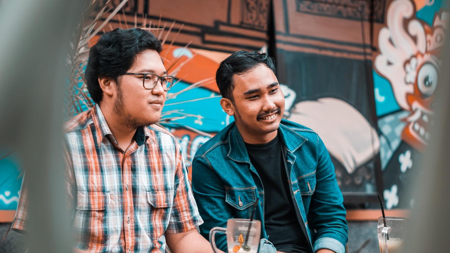 A gay couple (men) at a table 