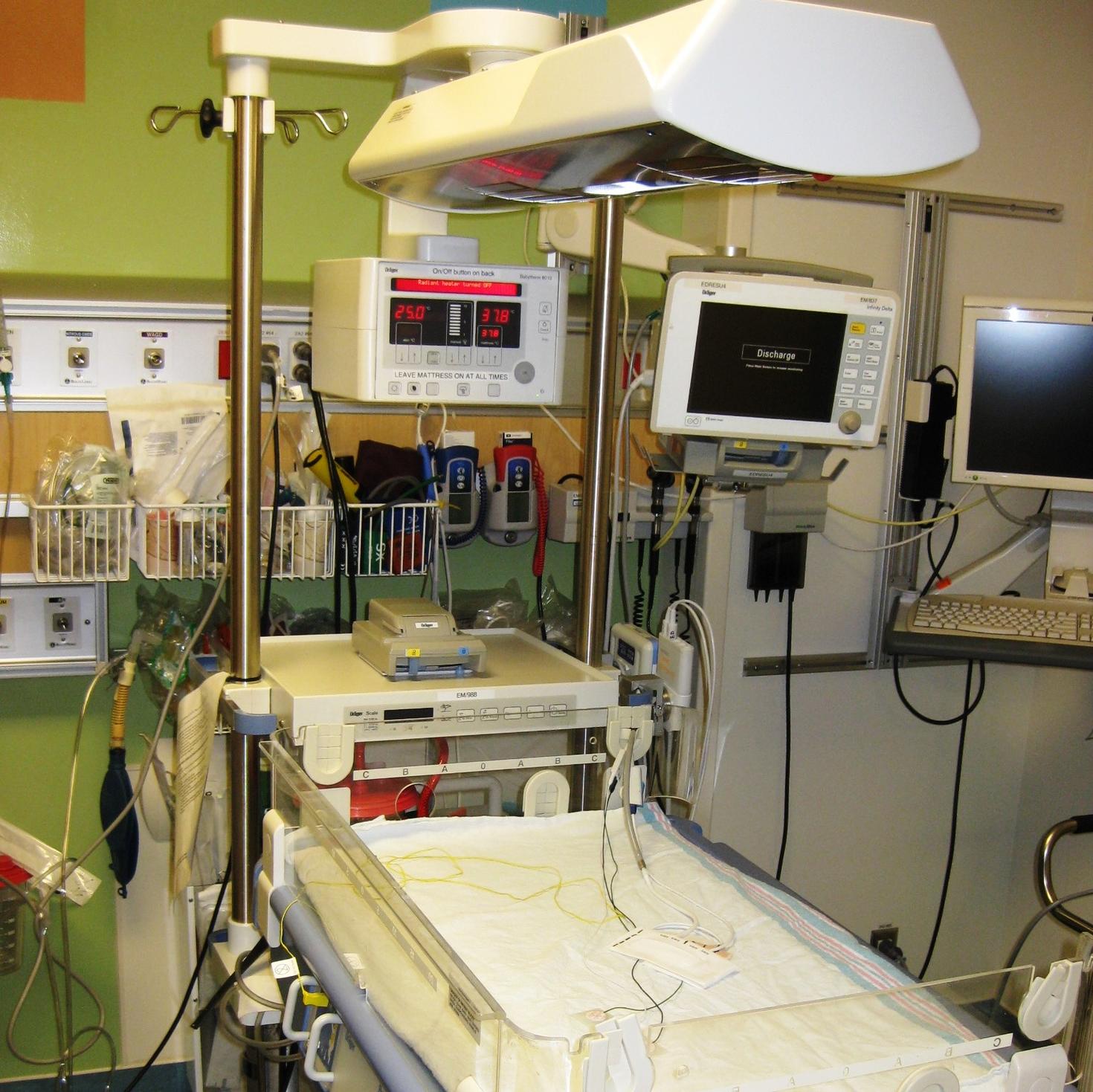 An emergency room with equipment and a patient bed