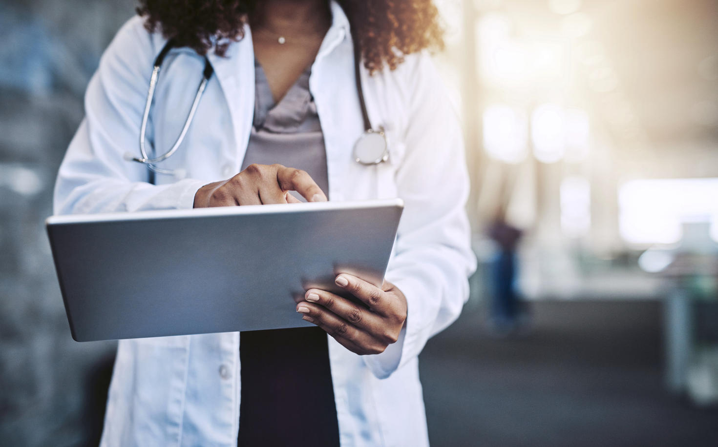 Cropped shot of an unrecognizable doctor using a digital tablet