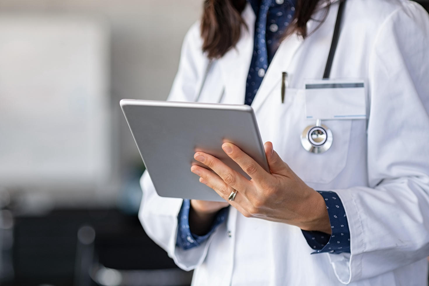 Close up of woman doctor hands using digital tablet at clinic