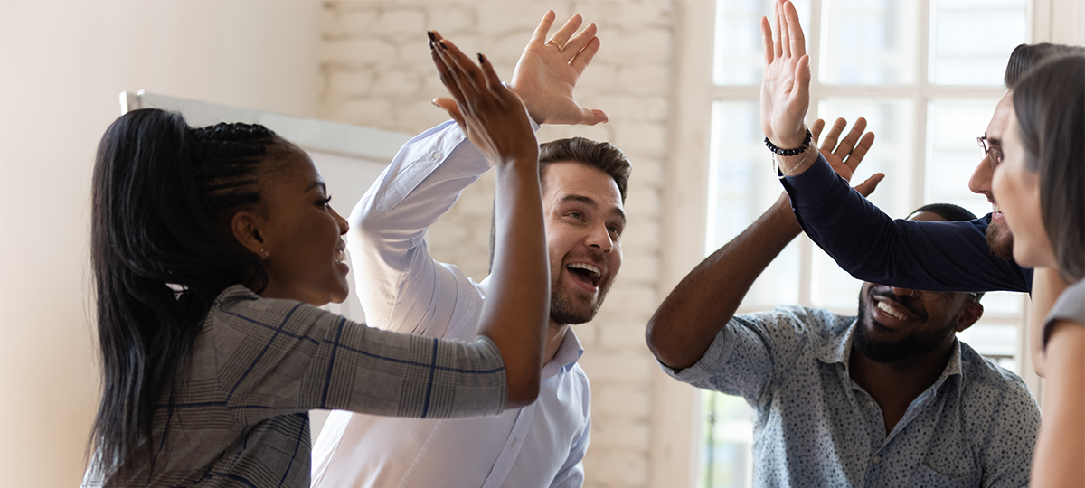 Happy multiracial business team give high five in office 