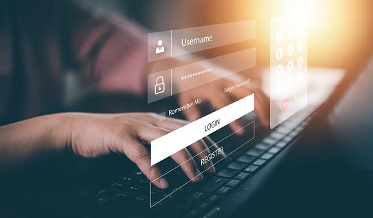 hands on lap top with login screen