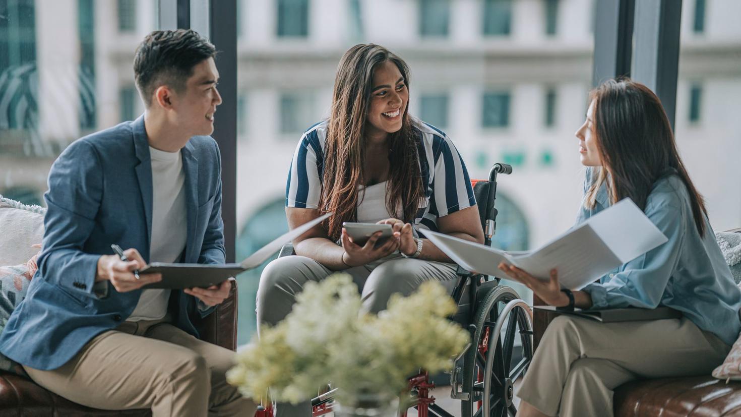 Three people sitting and talking