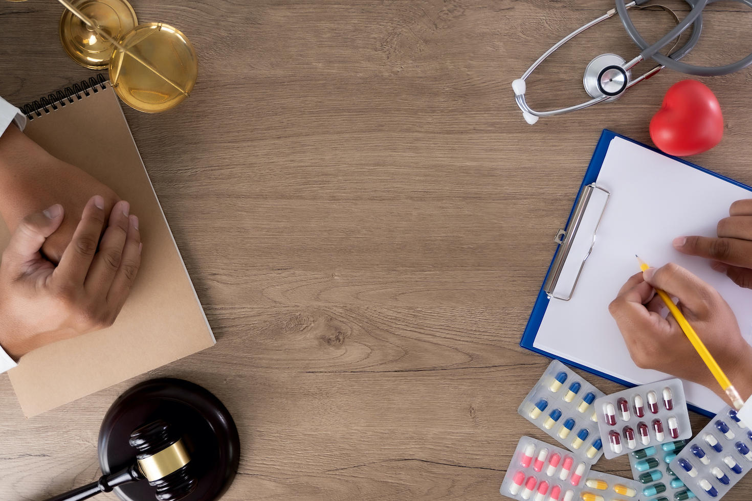 Medicines, stethoscope and a notepad kept on a table