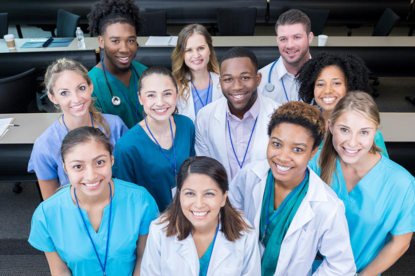 A large group of smiling medical students