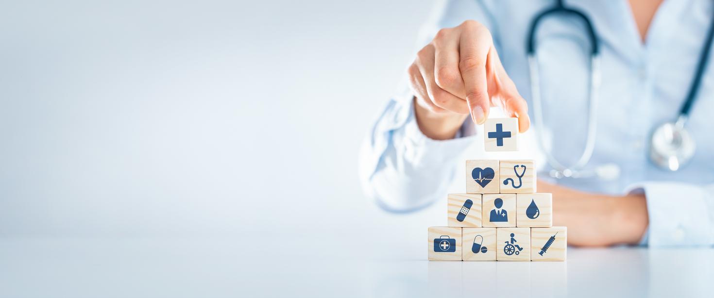 Hand arranging wood block with healthcare medical icon