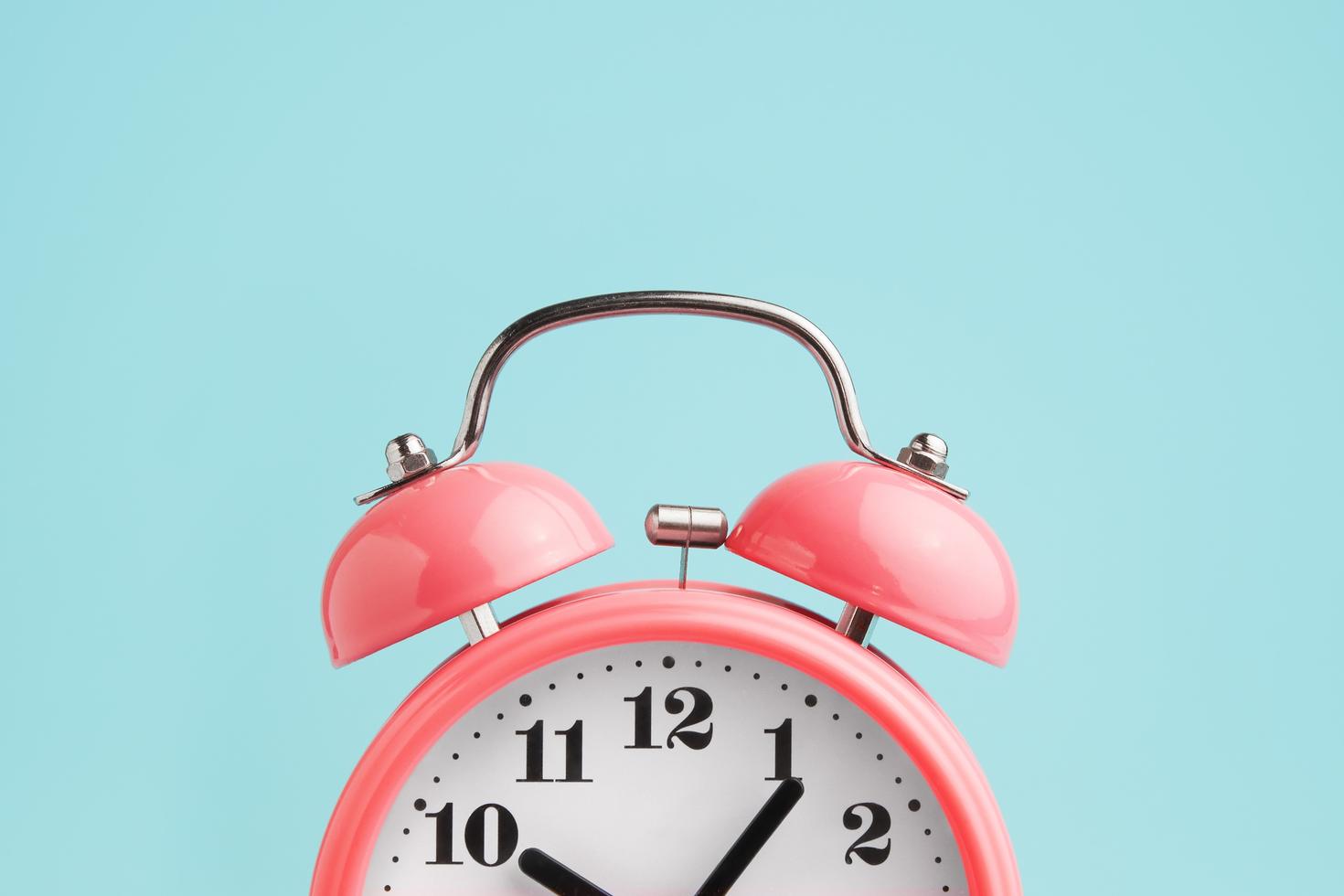 Red alarm clock on a blue background