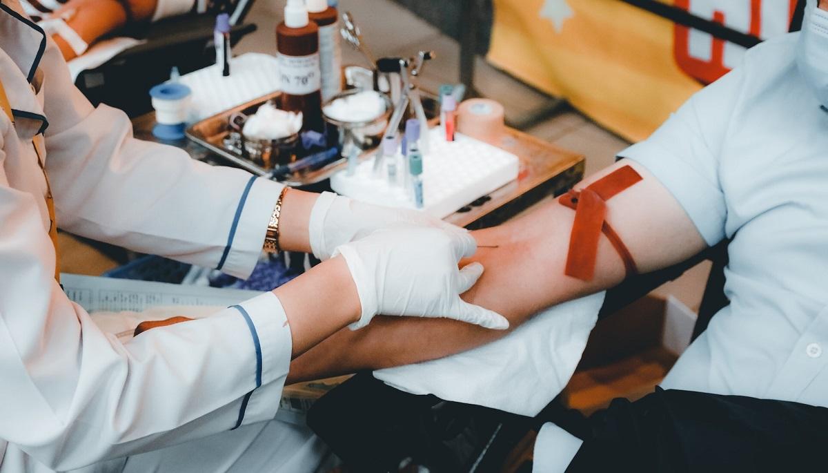 Medical personnel taking blood from person