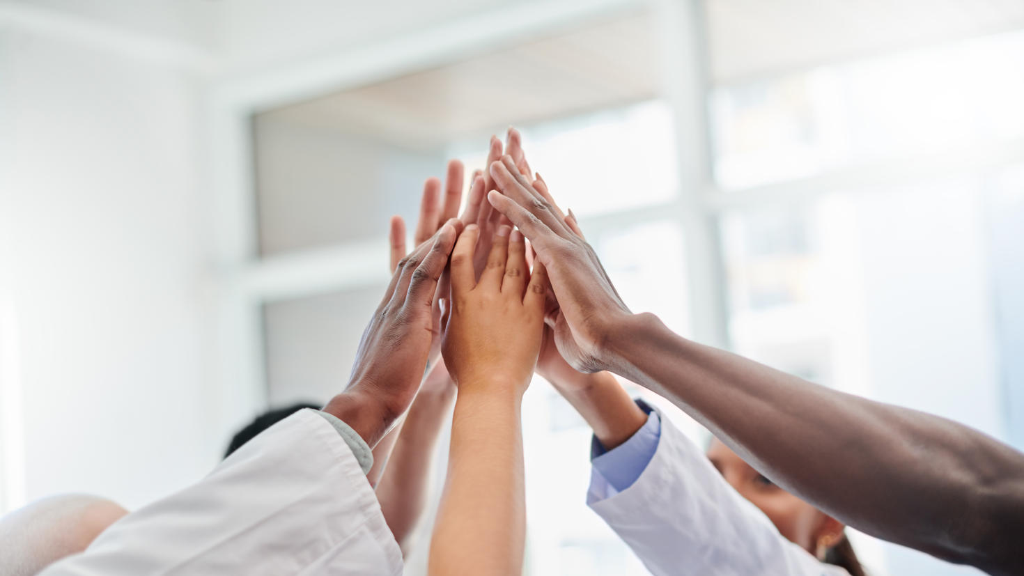Shot of a set of hands high fiving in victory
