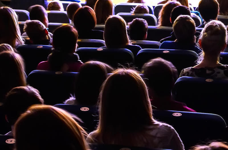Students sitting in a dark auditorium