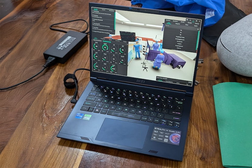 A laptop on a desk, with virtual reality on the screen.