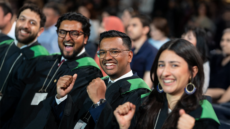 Students siting in an audience cheering