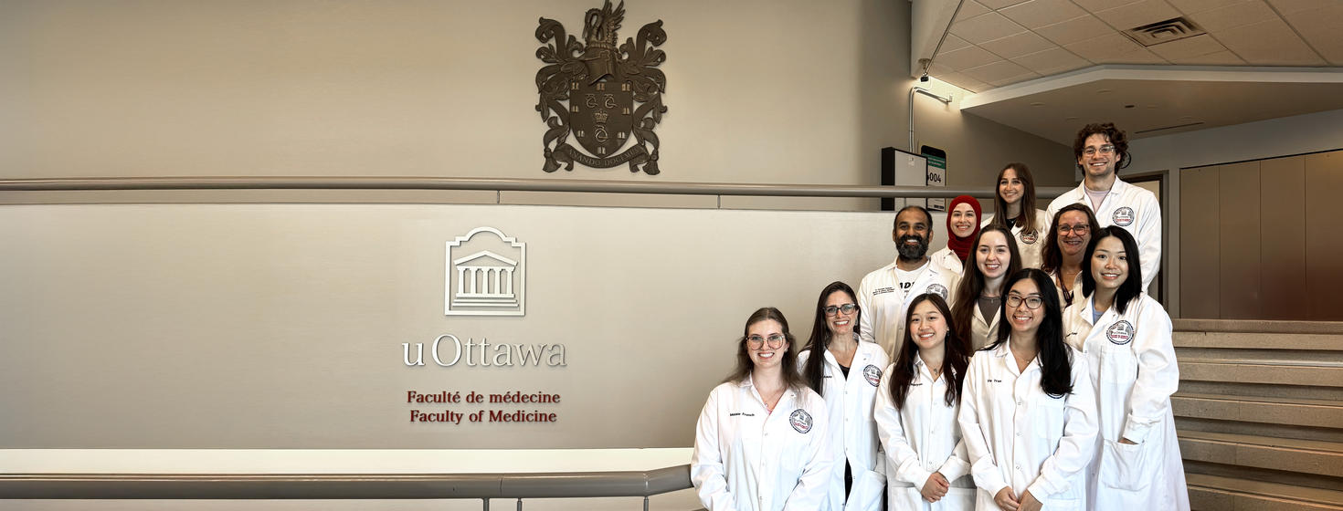 Group of medical students at uOttawa Faculty of Medicine posing in white lab coats.