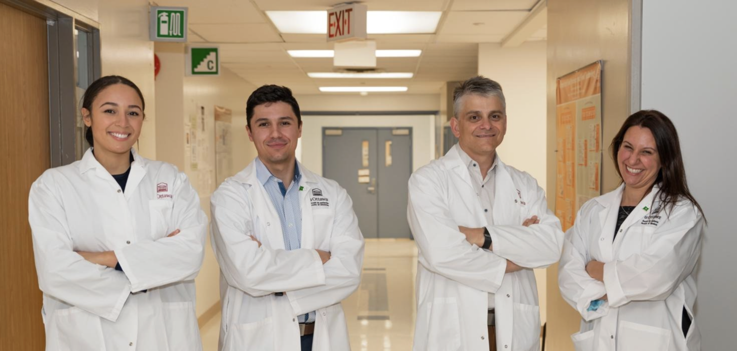 Group of pharmacists in lab coat standing in a university hallway