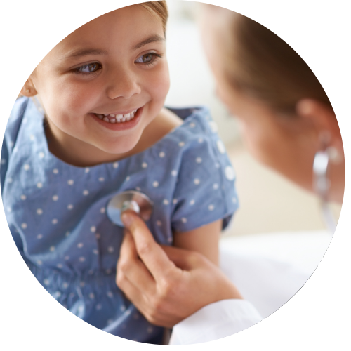 a kid smiling at a doctor