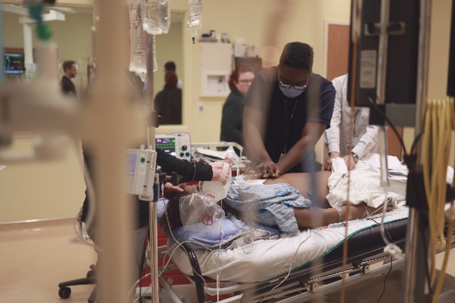 doctor performing resuscitation on patient 