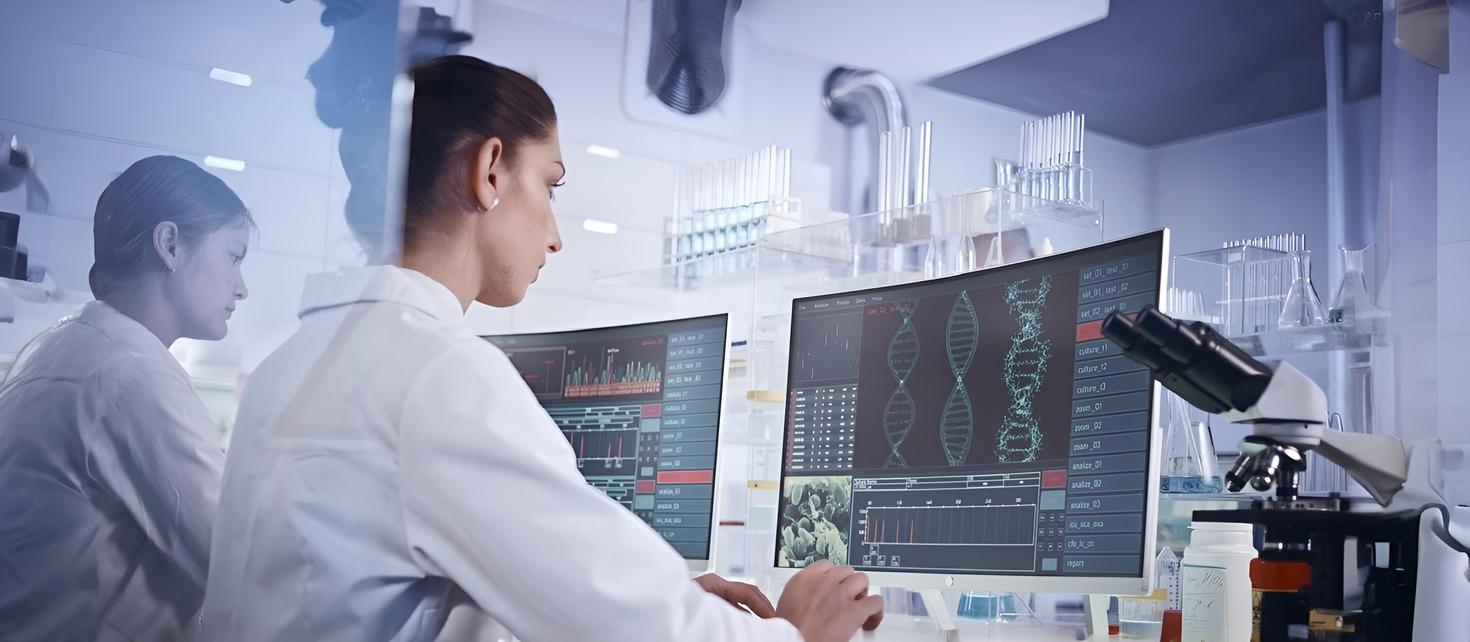 Female research team studying DNA mutations. Computer screens with DNA helix in foreground