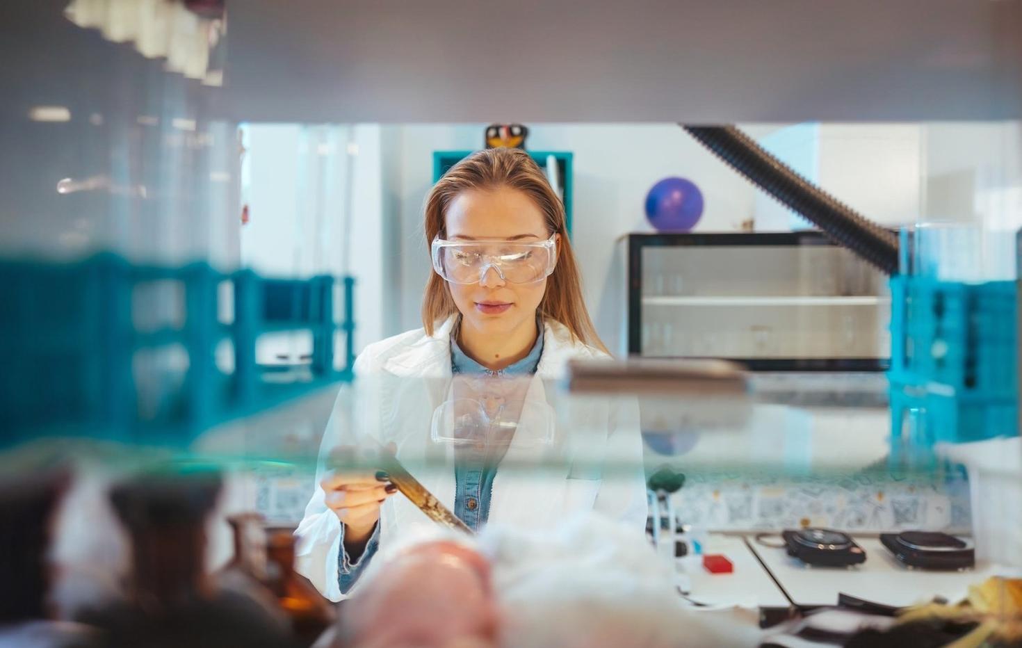 Scientist in a laboratory doing research and using lab equipment