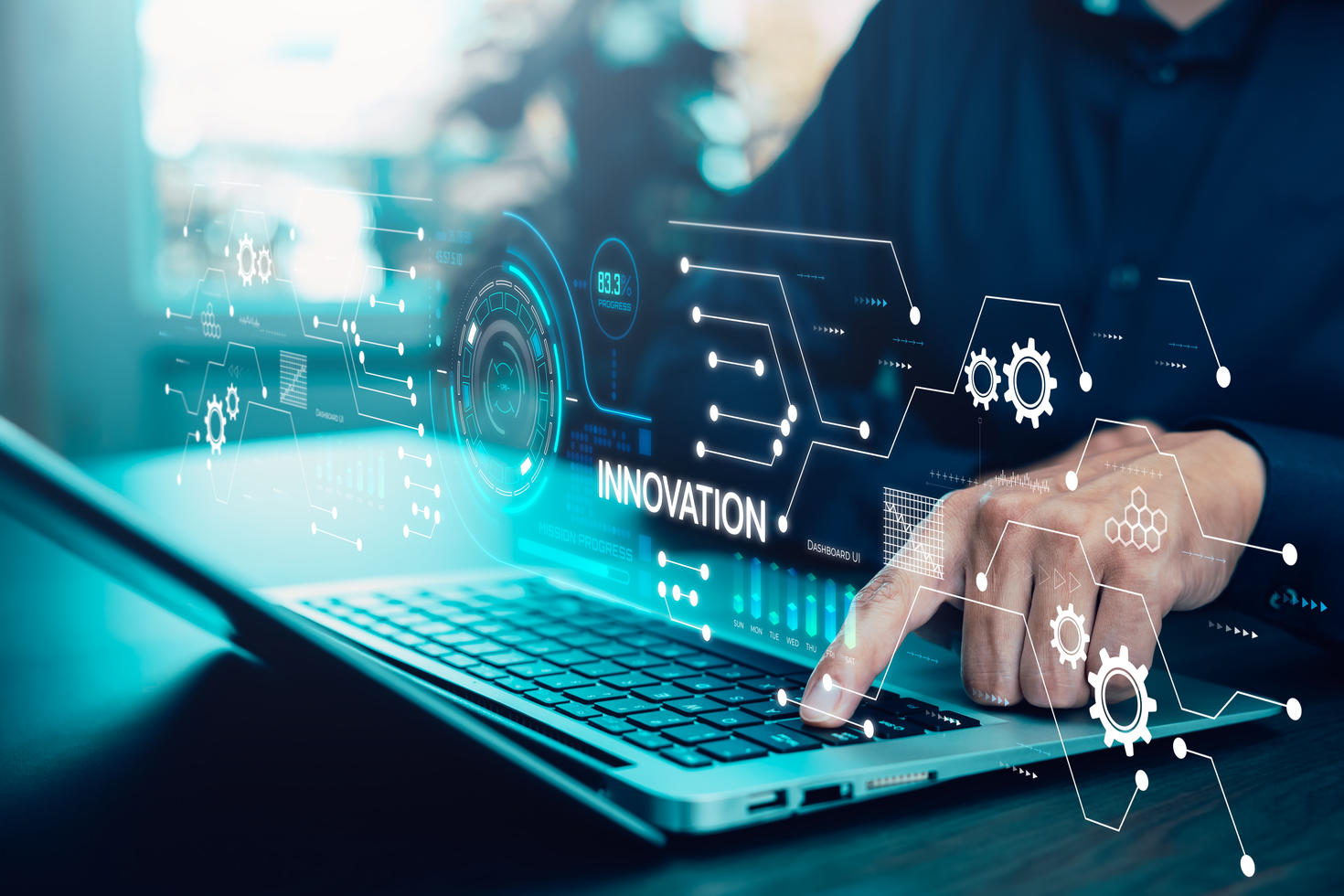 A person using a laptop, with transparent digital graphics and icons representing data flow, gears, and interconnected systems overlaid on the screen, symbolizing innovation, technology, and research-driven progress.