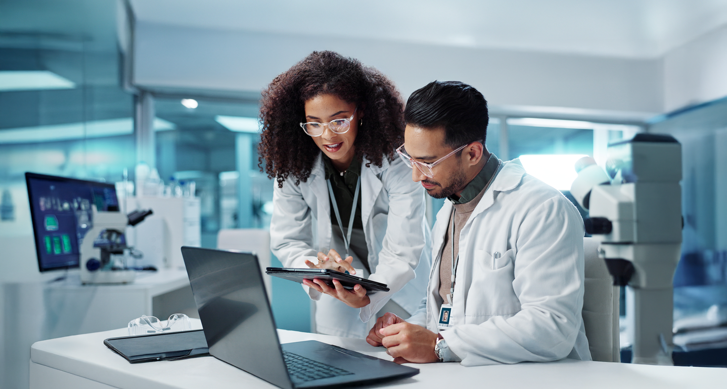 two doctors are looking at the tablet screen