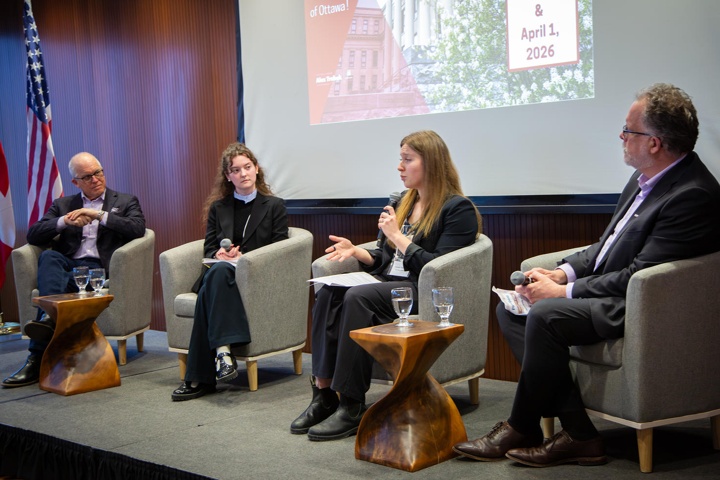 Dr. Meslin, Jessica Adams, Valeria Vasilyeva, Dr. Kinder sitting on stage during the Bromley Lecture