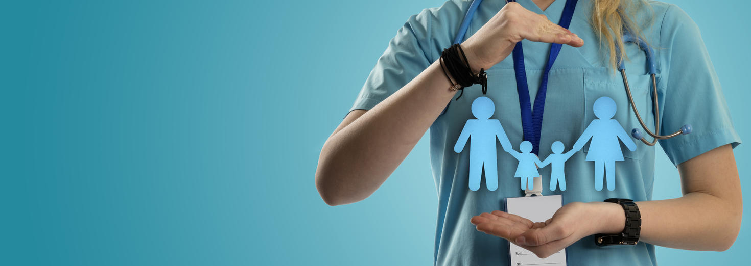 Doctor with hands framing a paper cutout family