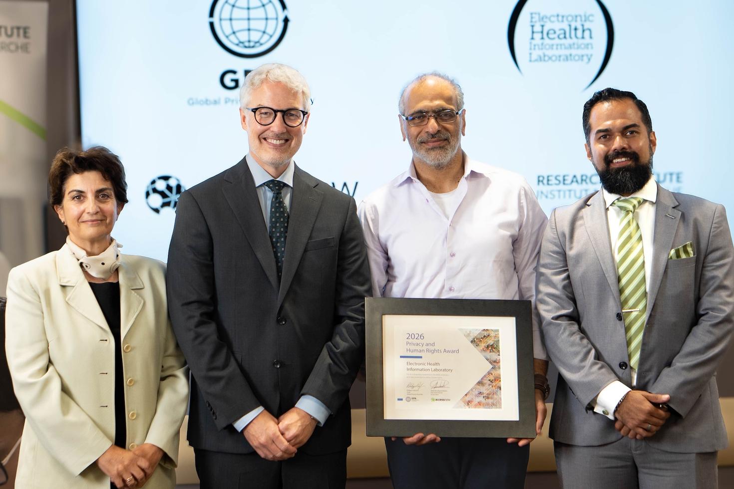 A researcher being presented with a plaque representing a high-profile award.