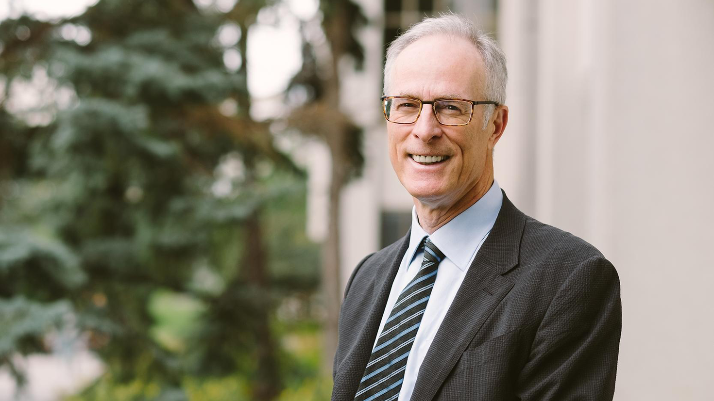 Dr. Phil Wells standing outside of the University of Ottawa Faculty of Medicine