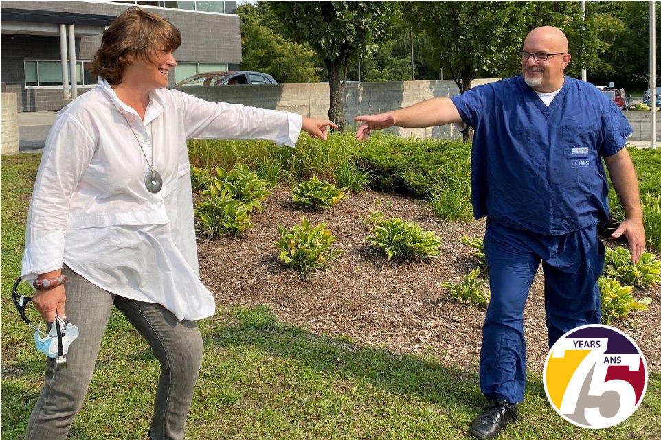 Dr. Marie-Hélène Chomienne stands outside Hôpital Montfort with Paul Shean, a member of the hospital’s cleaning staff.
