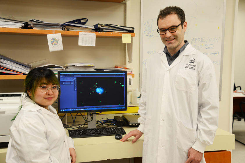 Photo of Truc Losier and Dr. Ryan Russell in their lab.