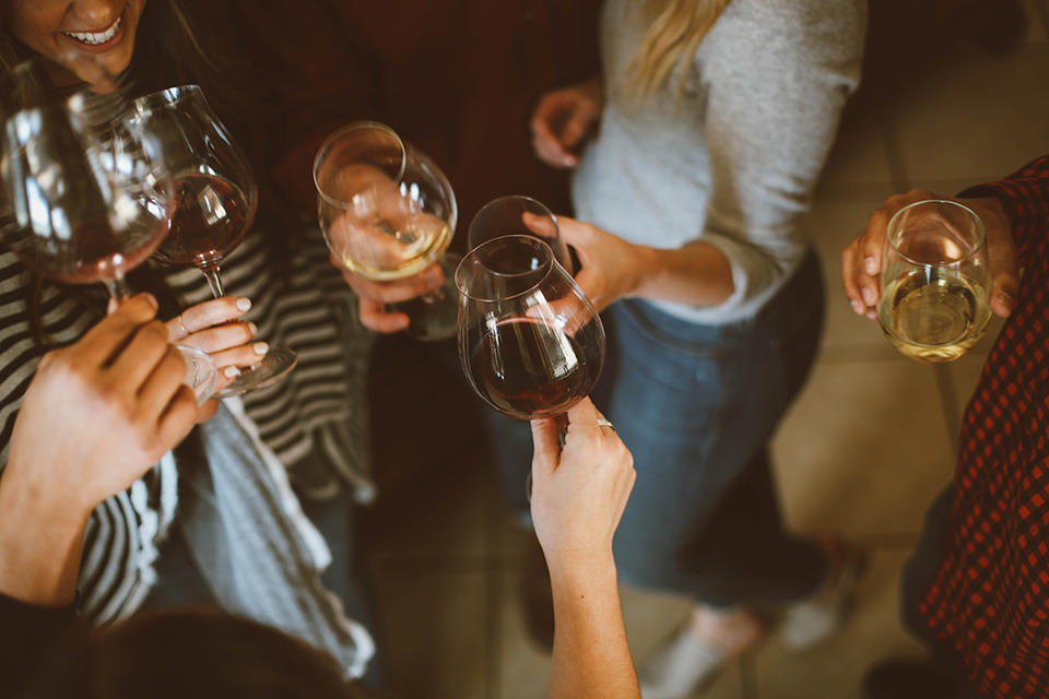  women holding glasses of alcohol