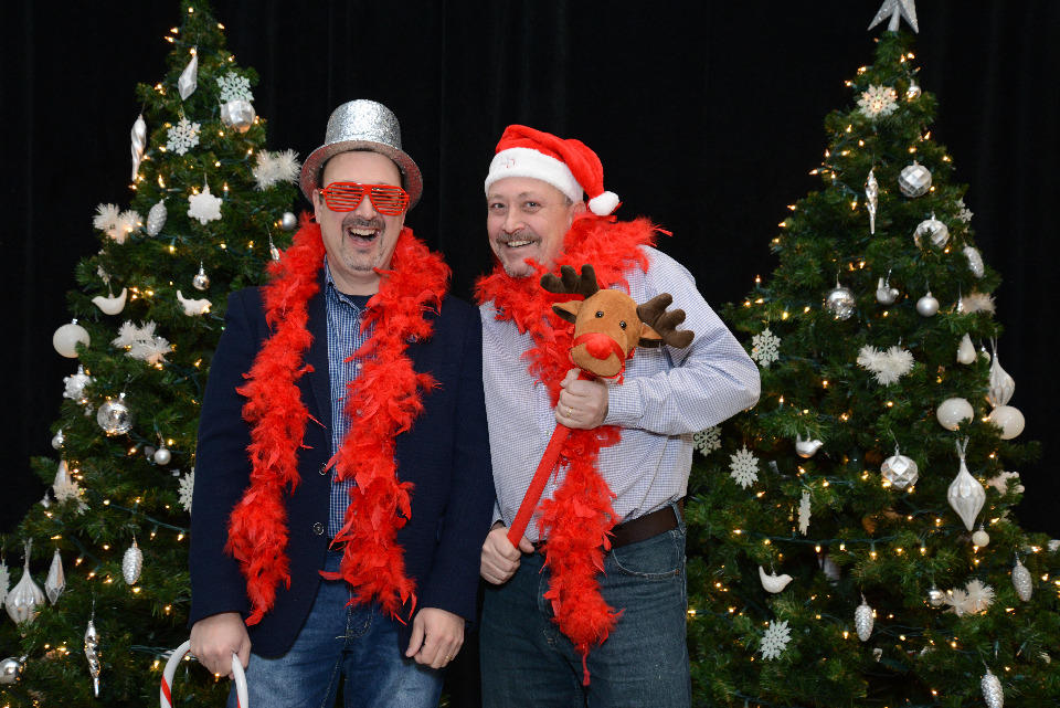 Two Faculty of Medicine employees having fun at the holiday photo booth.