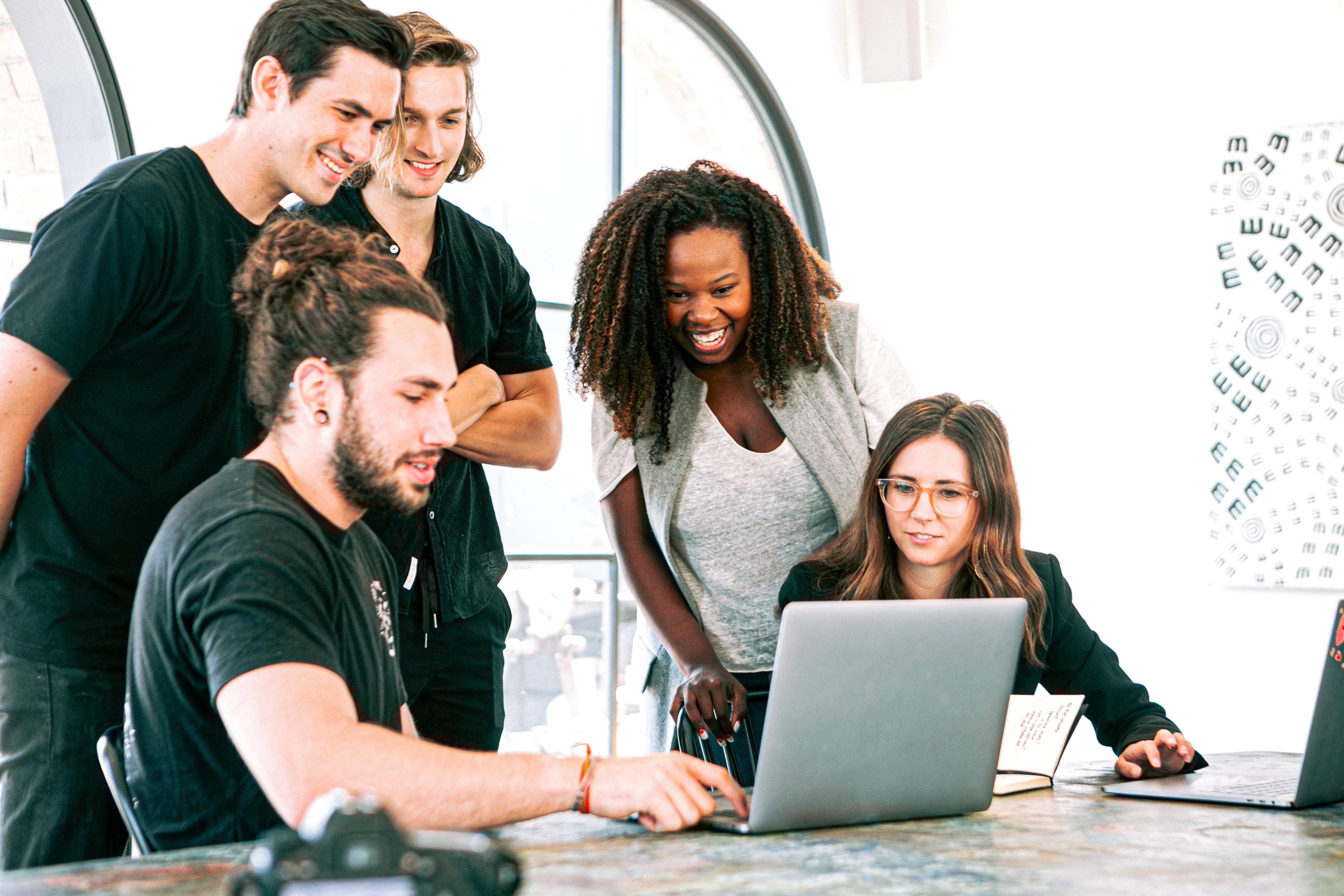 Group of students working around a computer