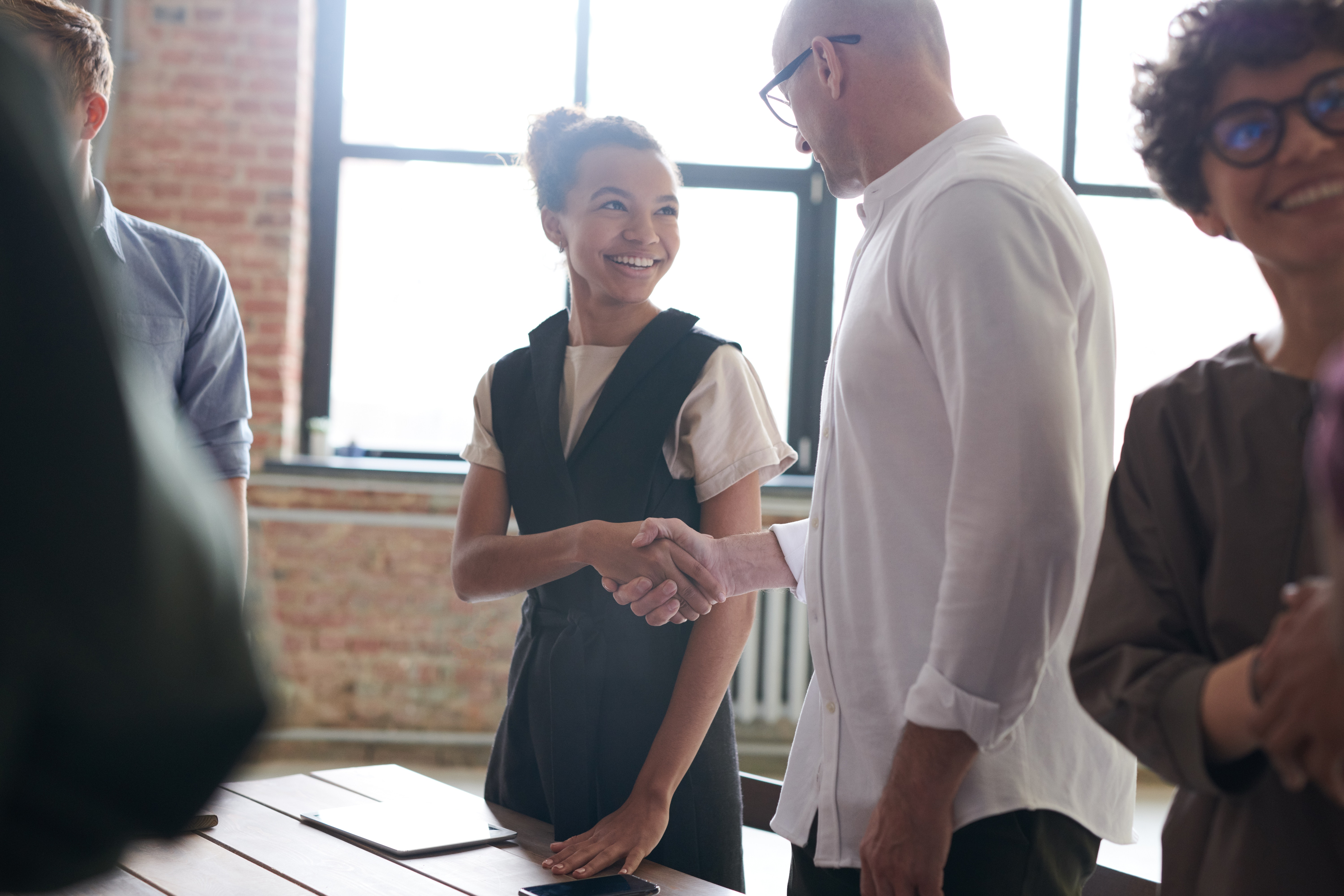 Woman shaking hands with a man
