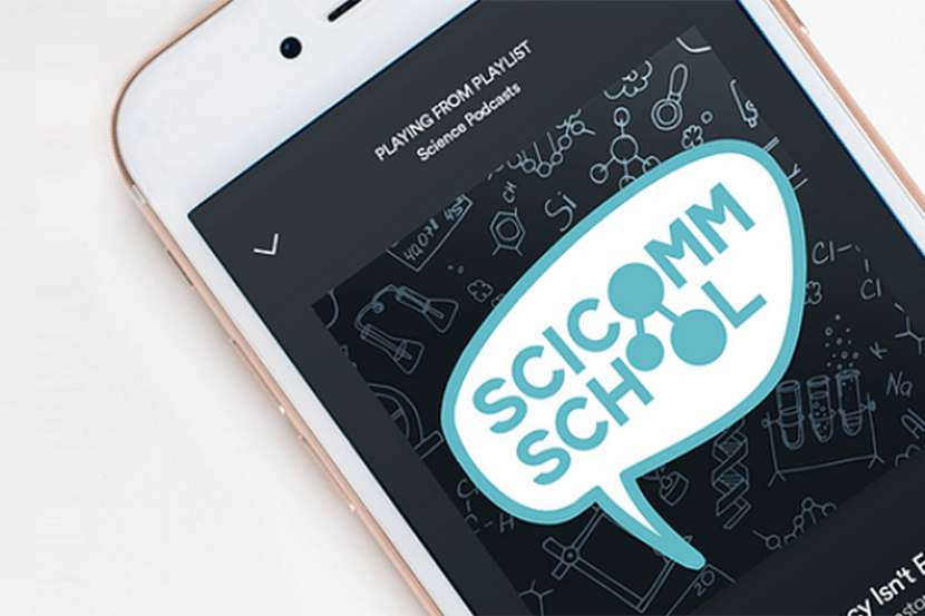 A phone with the Scicomm School logo on the screen.