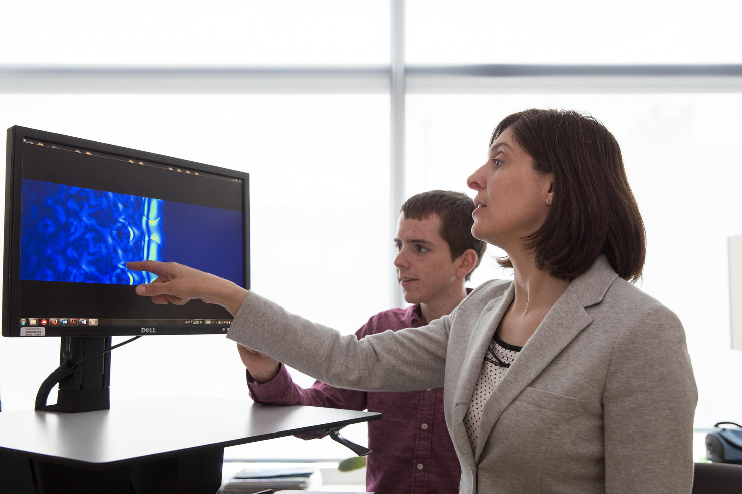 Prof. Lora Ramunno and student looking at a screen with data