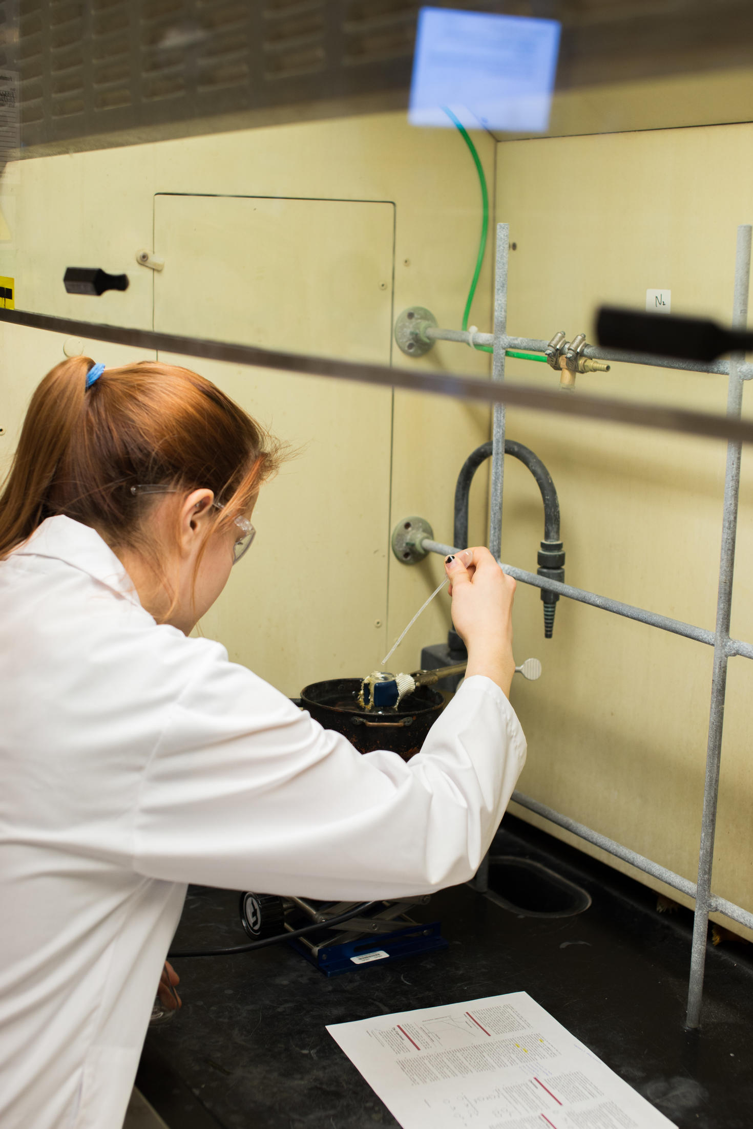 Female student working under a fumehood