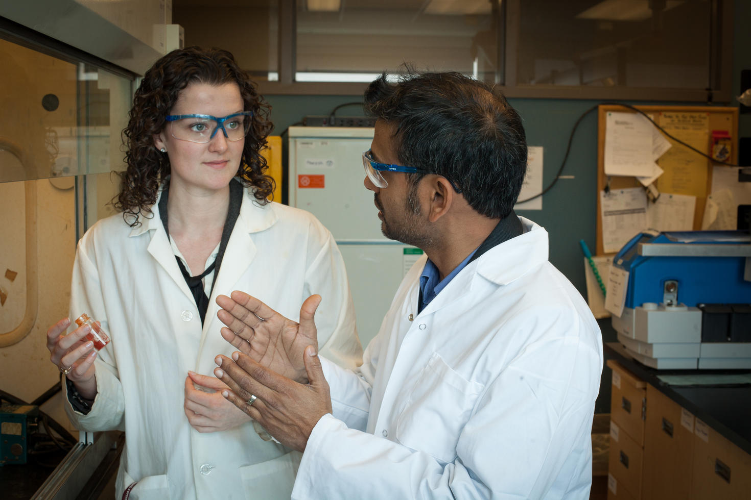 Student and professor talking in a lab